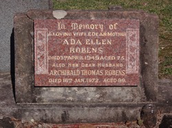 A bronze plaque set in stone, reading “In memory of a loving wife & dear mother Ada Ellen Robens, died 3rd April 1949, aged 75. Also her dear husband Archibald Thomas Robens, died 16th Jan 1972, aged 99.”