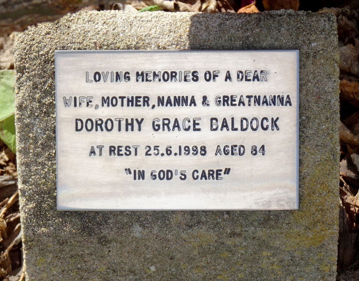 A memorial plaque reading "Loving memories of a dear wife, mother, Nanna & greatnanna, Dorothy Grace Baldock, at rest 25.6.1998 aged 84, In God's care."