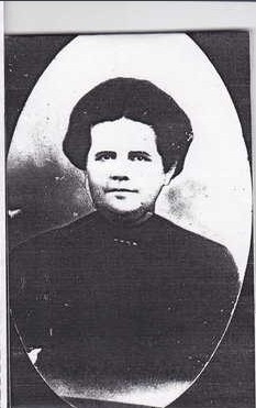 An oval studio portrait of a young woman with dark hair pulled back, wearing a high-necked dark dress.