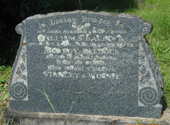 A weathered granite headstone reading "In loving remembrance of my dear husband and our father, William S. Baldock, died 15th April 1936, aged 69 years; also Roy Baldock ... aged 20 years; also infant children Stanley & Winnie."