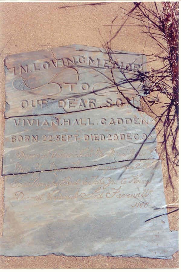 A thin grey slate headstone, cracked across, cut with the words In loving memory to our dear son Vivian Hall Cadden, born 22 Sept died 29 Dec 95, and a verse in script below.