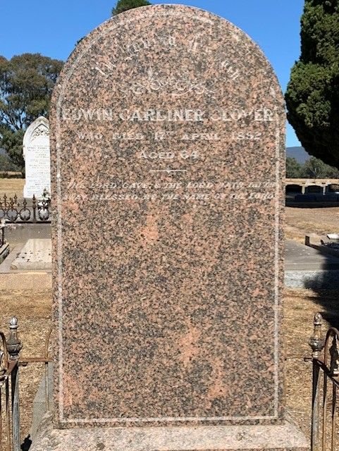 Pink granite headstone in a cemetery, inscribed to Edwin Gardiner Glover, who died 17th April, aged 64.