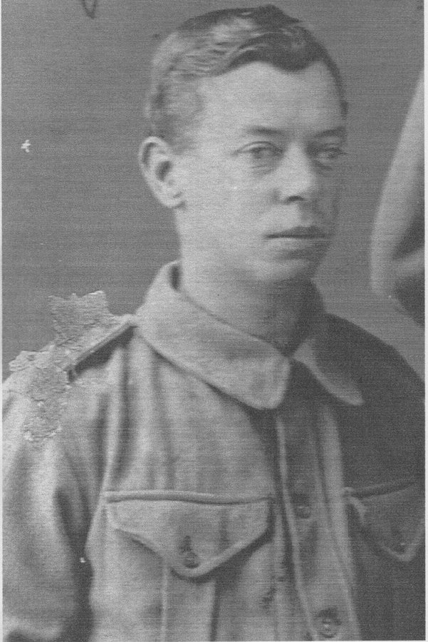 Black and white head-and-shoulders photograph of a young man in a First World War Australian service tunic with a shoulder colour patch.
